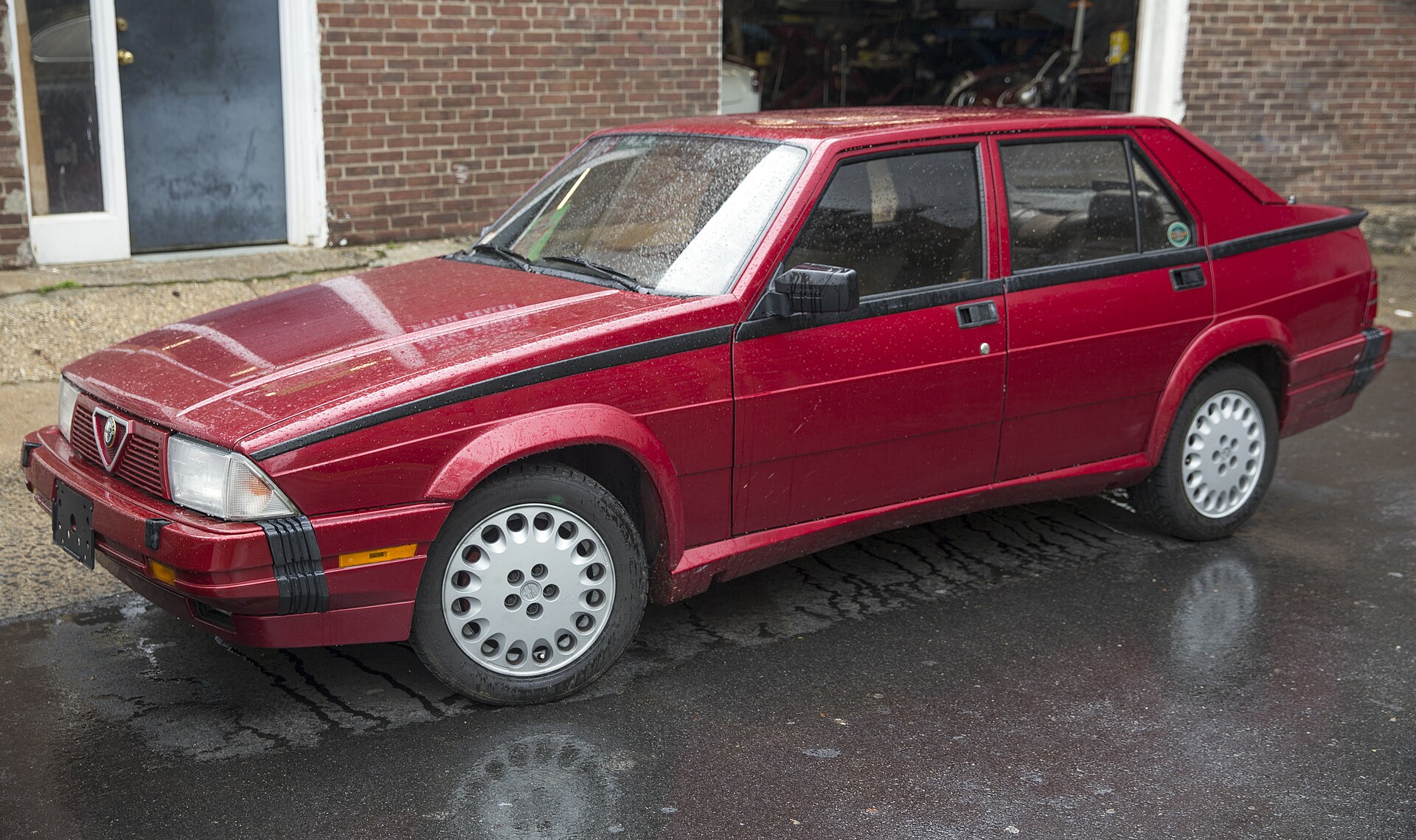 Red Alfa Romeo Milano saloon, front left view
