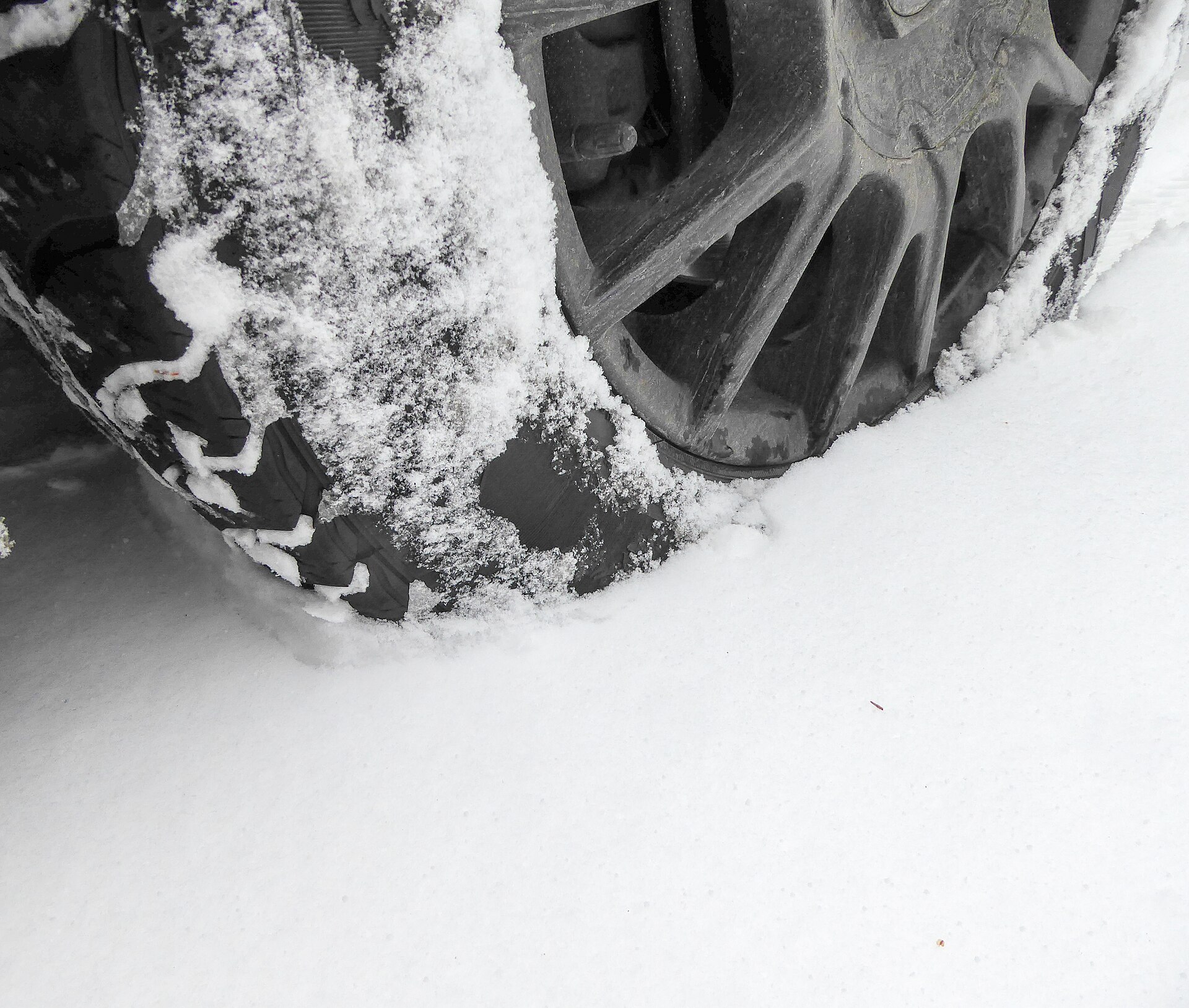 Winter tyre rolling through fresh snow