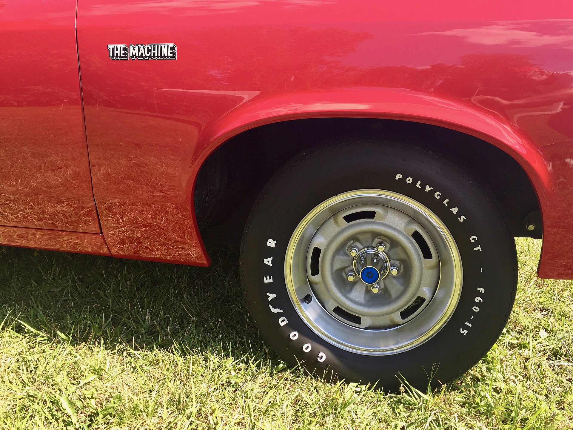 Red 1970 AMC Rebel Machine with black hood