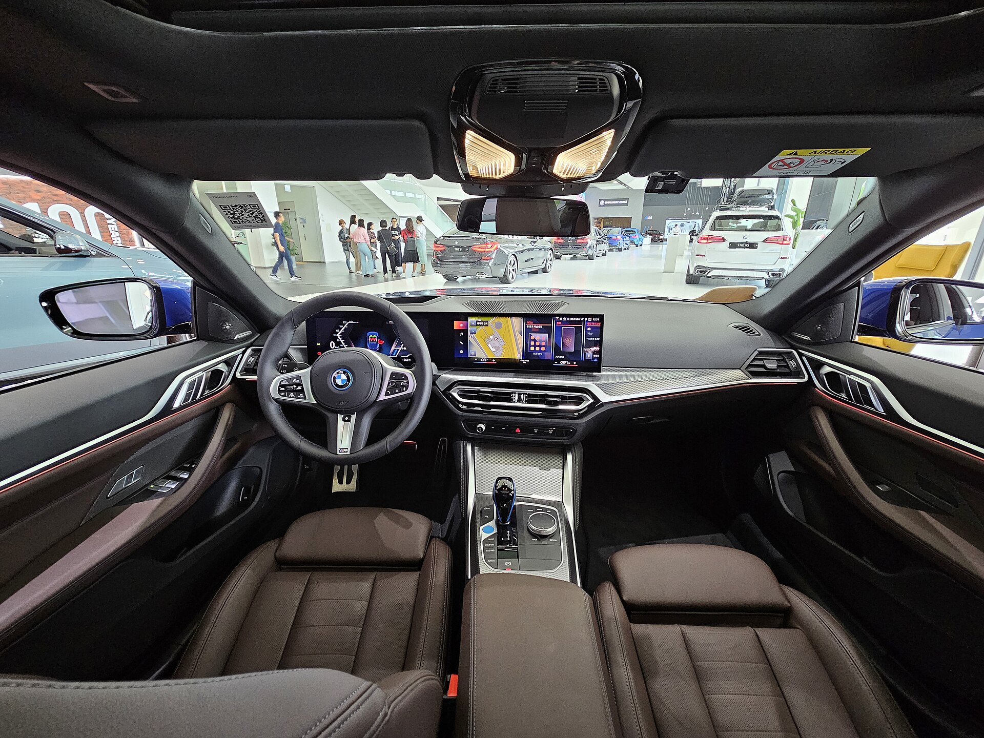 BMW i4 cabin with curved display and leather seats