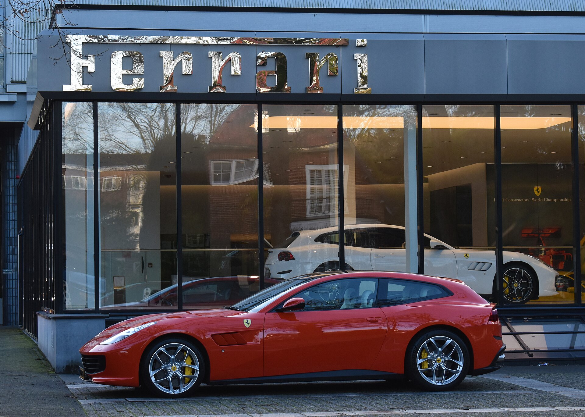 Two Ferrari GTC4Lusso cars, side and rear view