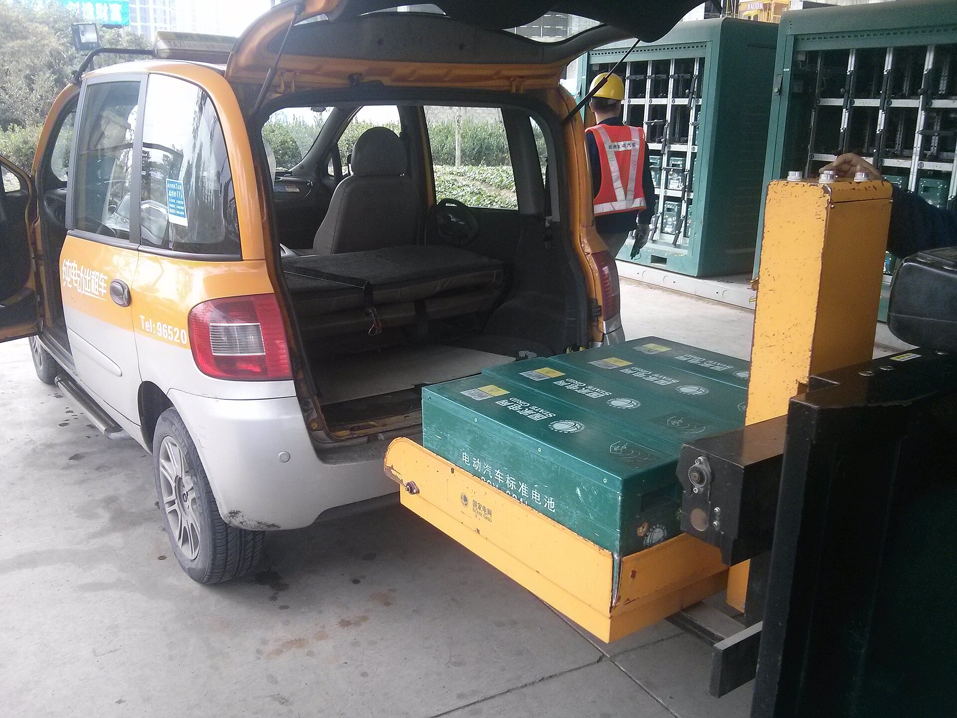 Zotye M300 EV electric taxi at a battery swap station