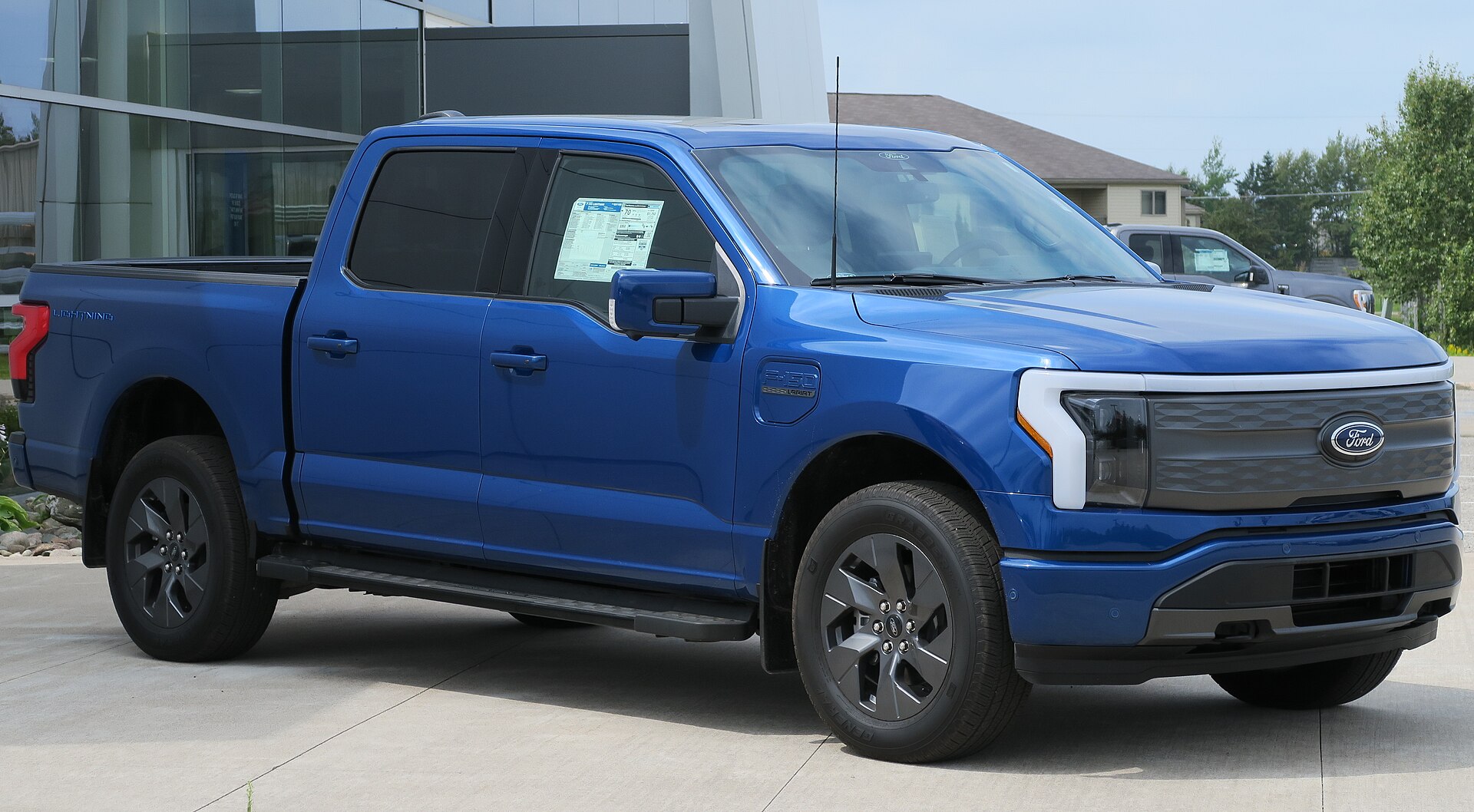 Blue Ford F-150 Lightning Lariat electric pickup, front three-quarter view