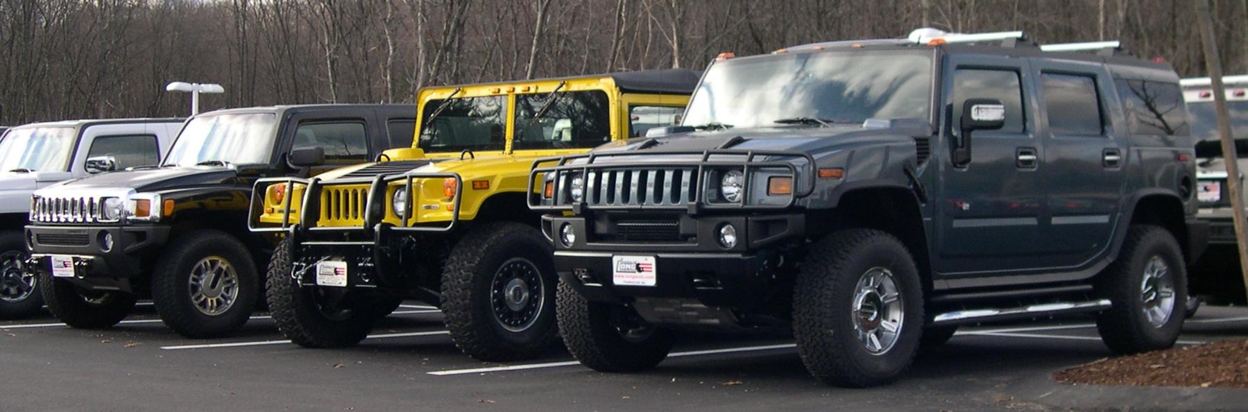 Three Hummer models parked together: H3, H1 and H2