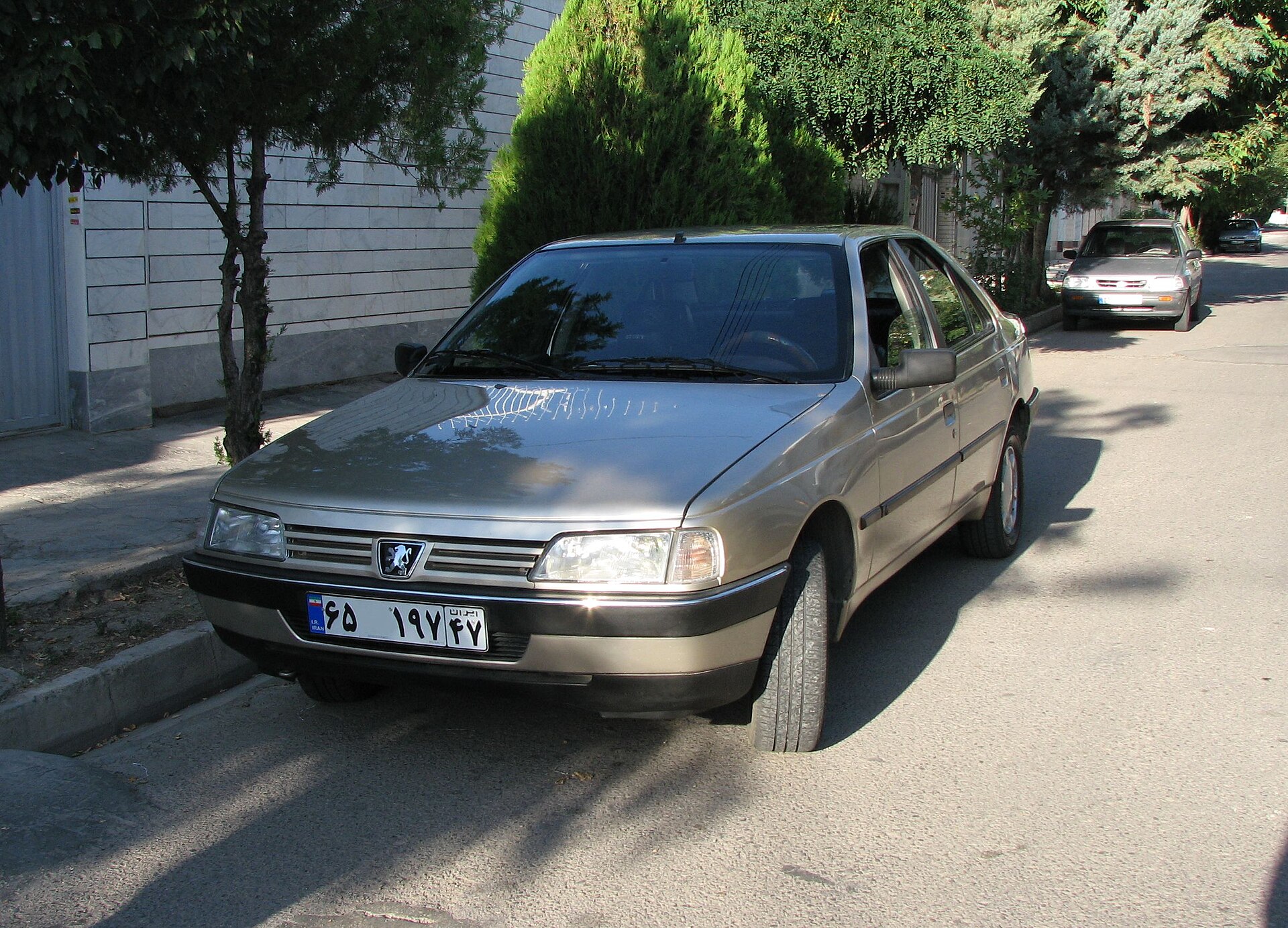 White Iranian-built Peugeot 405 saloon in a street