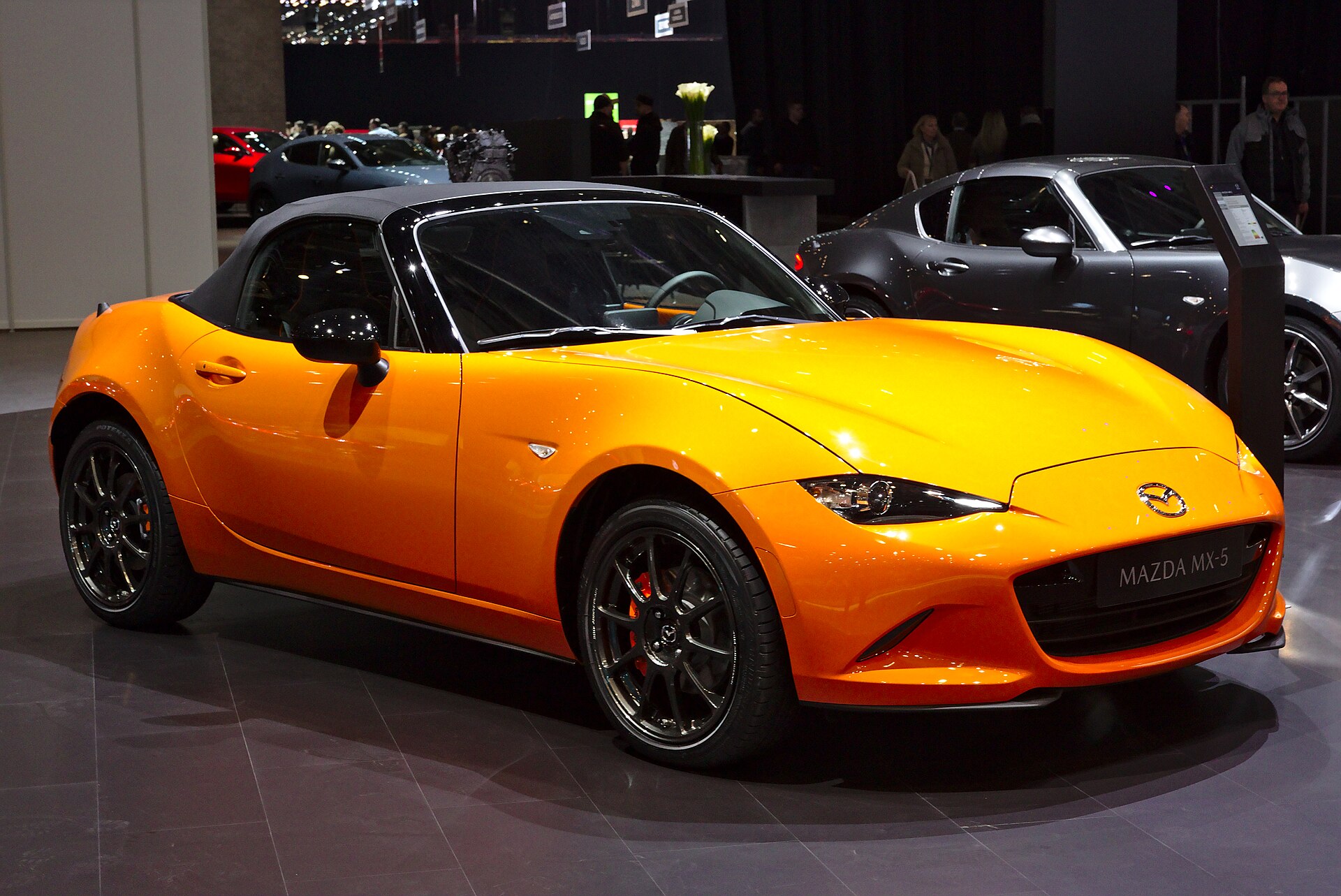 Orange Mazda MX-5 30th Anniversary on a show stand