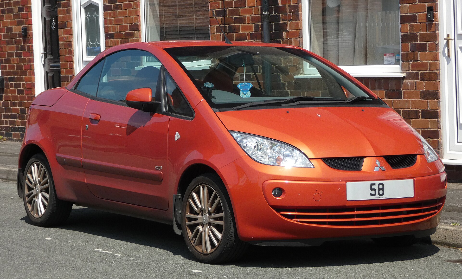 Orange Mitsubishi Colt CZC with folding hard top