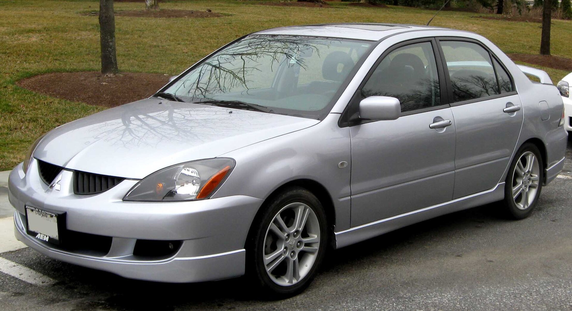 Mitsubishi Lancer Ralliart saloon of the early 2000s, front three-quarter view