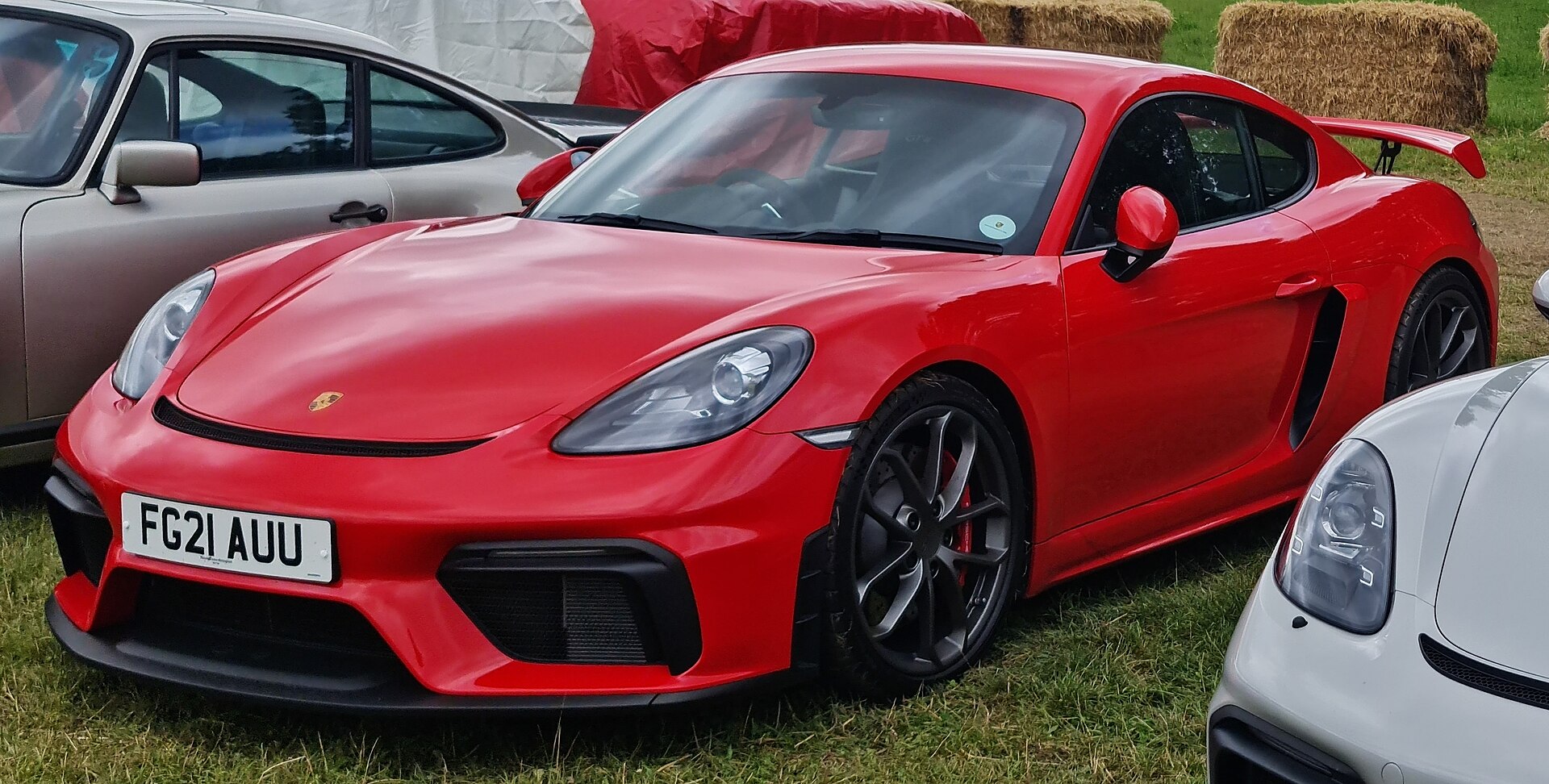 Red Porsche 718 Cayman GT4 with rear wing
