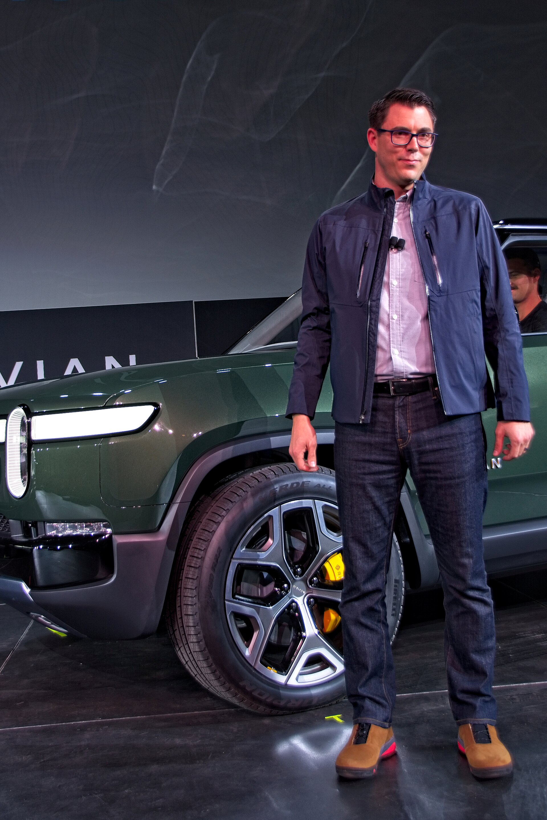 RJ Scaringe speaking on stage at the 2018 Los Angeles Auto Show
