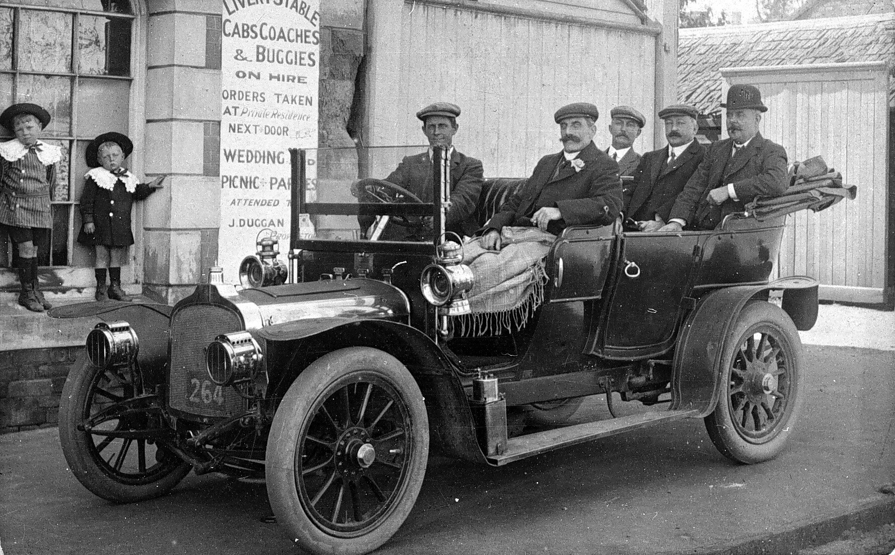 Historic photograph of an early motoring party