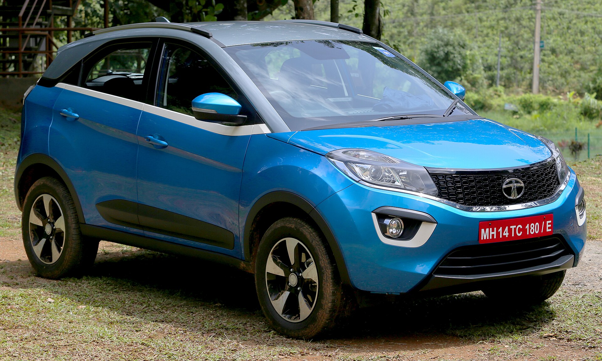 Blue Tata Nexon with a white roof, side view