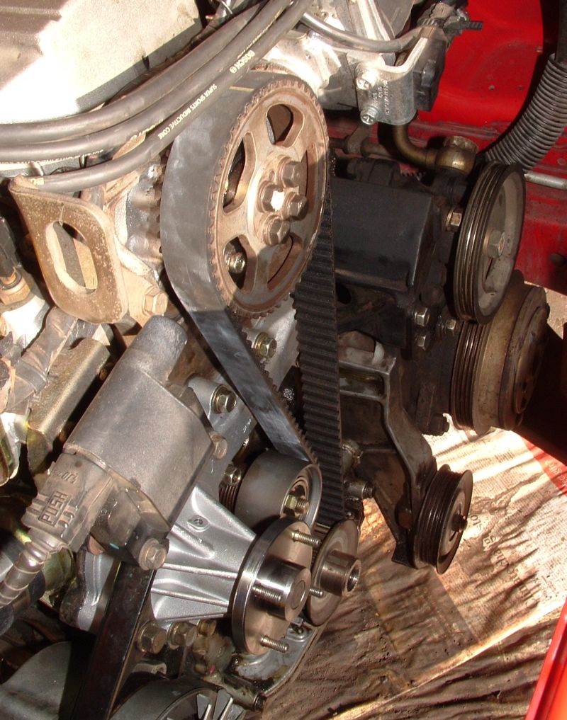 Timing belt and pulleys on the front of a Nissan RB30E engine
